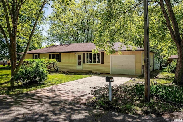 1401 Thomas St, Carterville, IL 62918 - ranch-style home featuring asphalt driveway and an attached garage