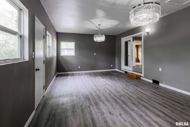 1401 Thomas St, Carterville, IL 62918 - unfurnished dining area featuring a chandelier, wood finished floors, and baseboards