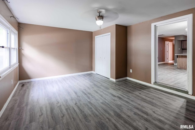 1401 Thomas St, Carterville, IL 62918 - unfurnished bedroom featuring wood finished floors, baseboards, a closet, and ceiling fan