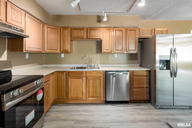 1401 Thomas St, Carterville, IL 62918 - kitchen featuring stainless steel appliances, a sink, under cabinet range hood, and light wood-style floors