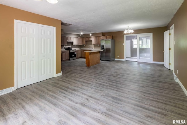 1401 Thomas St, Carterville, IL 62918 - kitchen featuring appliances with stainless steel finishes, open floor plan, a chandelier, baseboards, and light countertops