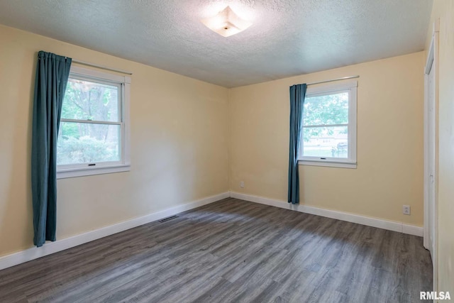 1401 Thomas St, Carterville, IL 62918 - unfurnished room with a textured ceiling, plenty of natural light, wood finished floors, and baseboards