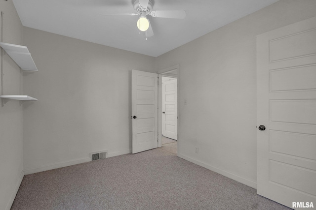 2910 Central Ave, Bettendorf, IA 52722 - empty room featuring carpet floors, a ceiling fan, and baseboards