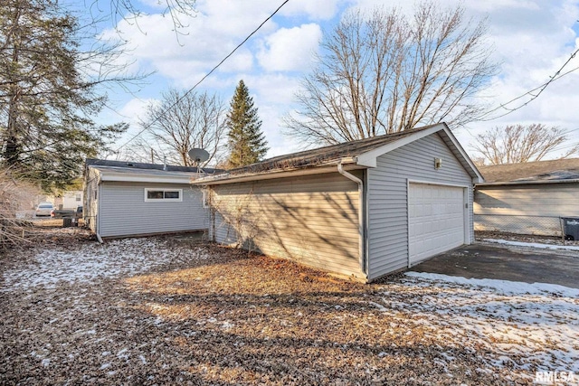 2910 Central Ave, Bettendorf, IA 52722 - snow covered garage featuring a detached garage and driveway
