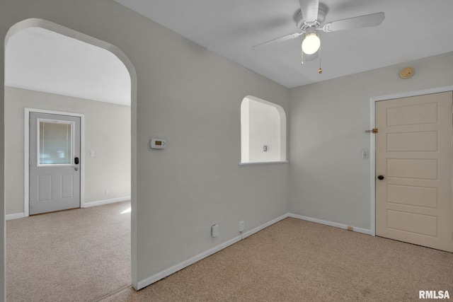 2910 Central Ave, Bettendorf, IA 52722 - empty room with carpet floors, ceiling fan, arched walkways, and baseboards