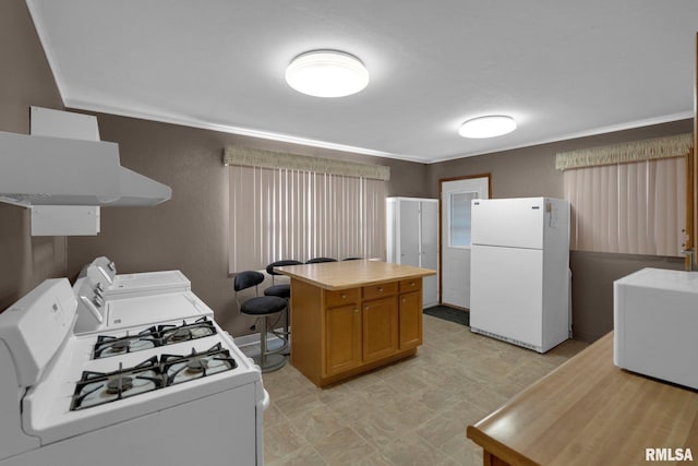 2910 Central Ave, Bettendorf, IA 52722 - kitchen featuring white appliances, crown molding, washer / dryer, exhaust hood, and a center island