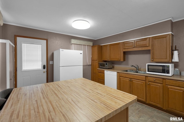 2910 Central Ave, Bettendorf, IA 52722 - kitchen with white appliances, a sink, crown molding, and brown cabinetry