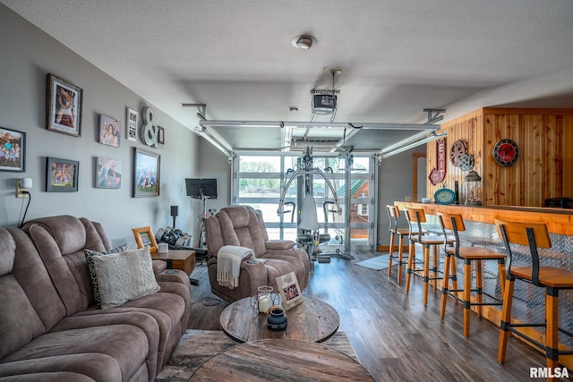 1012 Viaduct Rd, Savanna, IL 61074 - living area featuring a garage, wood finished floors, a textured ceiling, and a bar