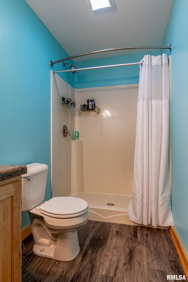 1012 Viaduct Rd, Savanna, IL 61074 - full bath with wood finished floors, toilet, curtained shower, vanity, and baseboards
