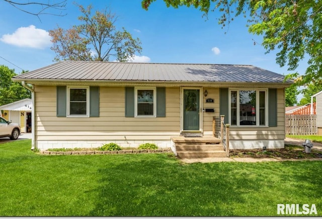 view of front of property with a front yard and metal roof