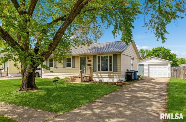 single story home with an outdoor structure, asphalt driveway, a garage, and metal roof