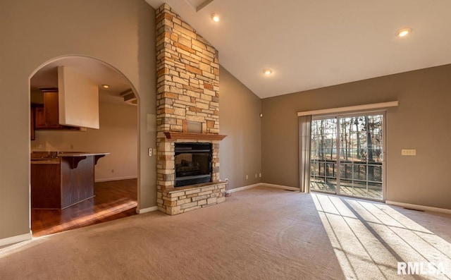 2505 Joel Dr, Herrin, IL 62948 - unfurnished living room with carpet, high vaulted ceiling, baseboards, arched walkways, and a fireplace