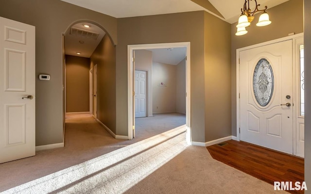 2505 Joel Dr, Herrin, IL 62948 - carpeted foyer entrance featuring arched walkways, a chandelier, and baseboards