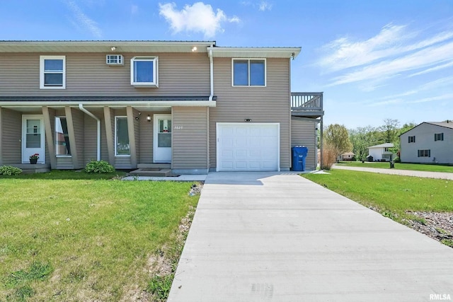 view of front of property featuring a front yard, concrete driveway, a garage, and covered porch