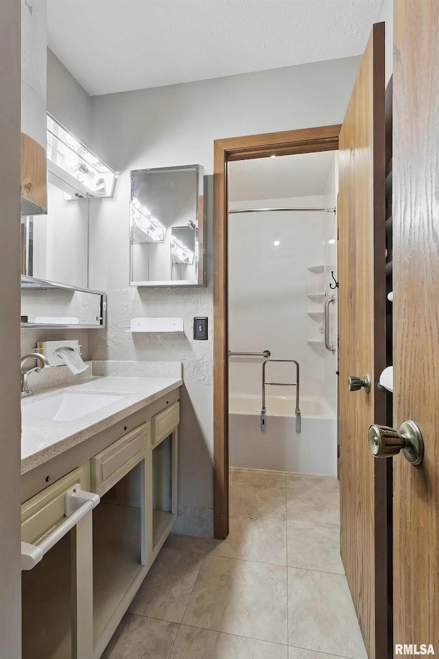 bathroom featuring vanity, washtub / shower combination, and tile patterned floors