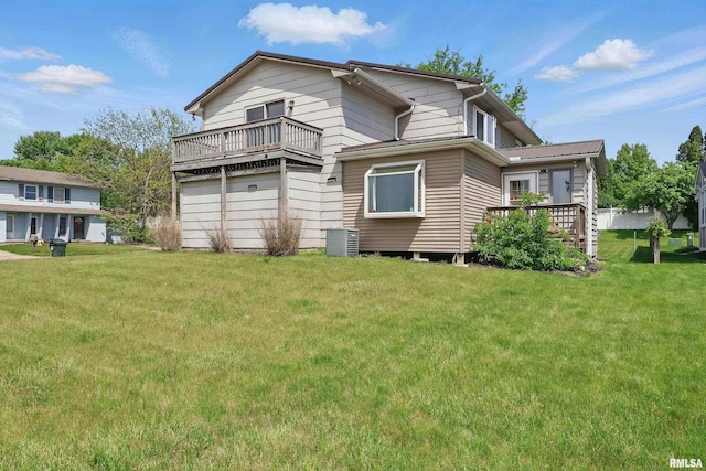 back of house with a balcony, a yard, and central AC unit