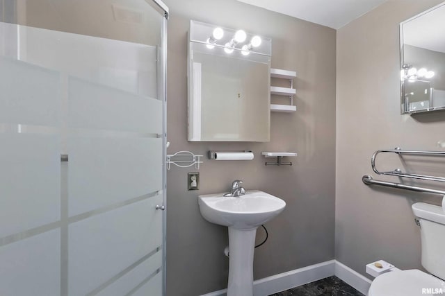 bathroom with baseboards and toilet