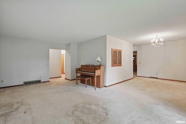 3816 Woodland Ct, Davenport, IA 52807 - carpeted empty room featuring a chandelier, baseboards, and a textured ceiling