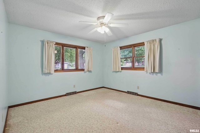 3816 Woodland Ct, Davenport, IA 52807 - carpeted empty room featuring a ceiling fan, a textured ceiling, and baseboards