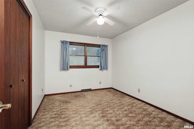 3816 Woodland Ct, Davenport, IA 52807 - unfurnished bedroom featuring carpet, a textured ceiling, a closet, baseboards, and a ceiling fan