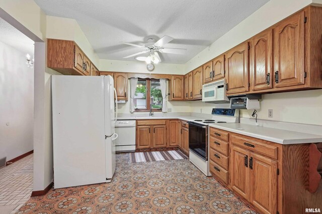 3816 Woodland Ct, Davenport, IA 52807 - kitchen with white appliances, ceiling fan, brown cabinets, light countertops, and a sink