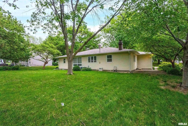 3816 Woodland Ct, Davenport, IA 52807 - back of house with a yard and a chimney