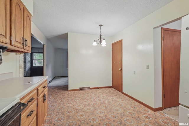 3816 Woodland Ct, Davenport, IA 52807 - kitchen with a chandelier, light countertops, a textured ceiling, hanging light fixtures, and brown cabinets