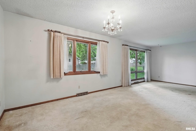 3816 Woodland Ct, Davenport, IA 52807 - carpeted spare room with a chandelier, a textured ceiling, and baseboards