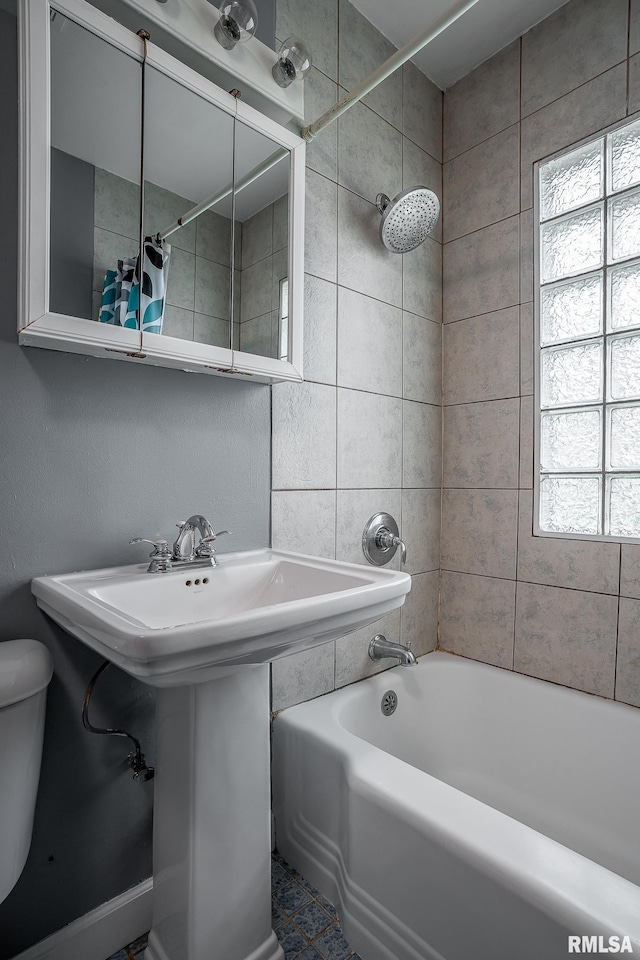full bathroom featuring toilet, shower / bath combo, and a sink