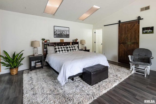 6443 Roberts Rd, Marion, IL 62959 - bedroom with vaulted ceiling, wood finished floors, baseboards, and a barn door