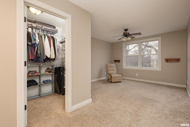 9932 123rd St, Davenport, IA 52804 - living area with carpet floors, ceiling fan, and baseboards