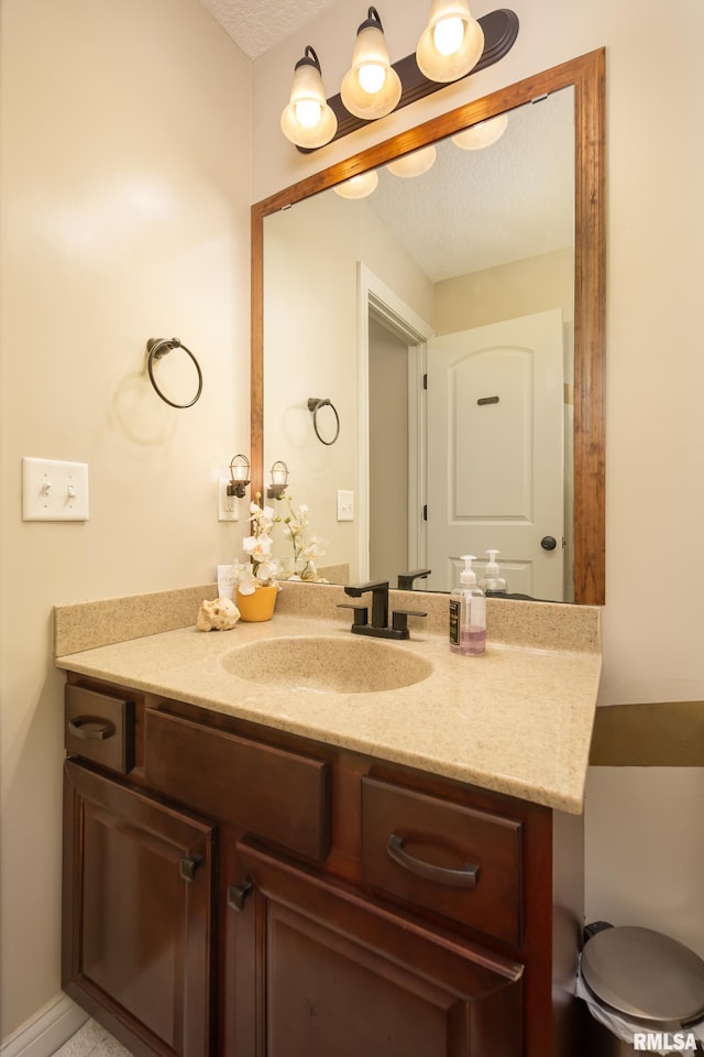 9932 123rd St, Davenport, IA 52804 - bathroom featuring vanity and a textured ceiling