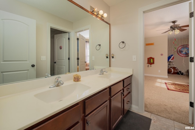 9932 123rd St, Davenport, IA 52804 - bathroom featuring double vanity, ceiling fan, baseboards, and tile patterned flooring