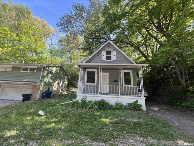 1935 12th Ave, Moline, IL 61265 - view of front of property with covered porch and an attached garage