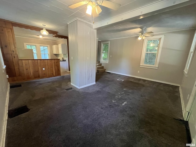 1935 12th Ave, Moline, IL 61265 - unfurnished living room with ceiling fan, ornamental molding, stairway, baseboards, and dark carpet