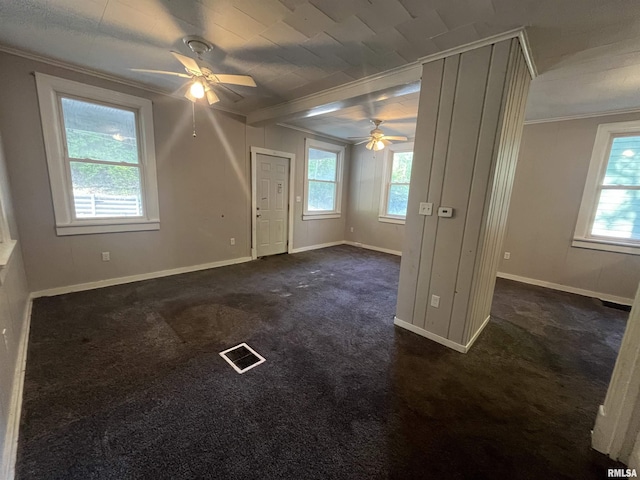 1935 12th Ave, Moline, IL 61265 - spare room featuring a ceiling fan, crown molding, baseboards, and dark carpet