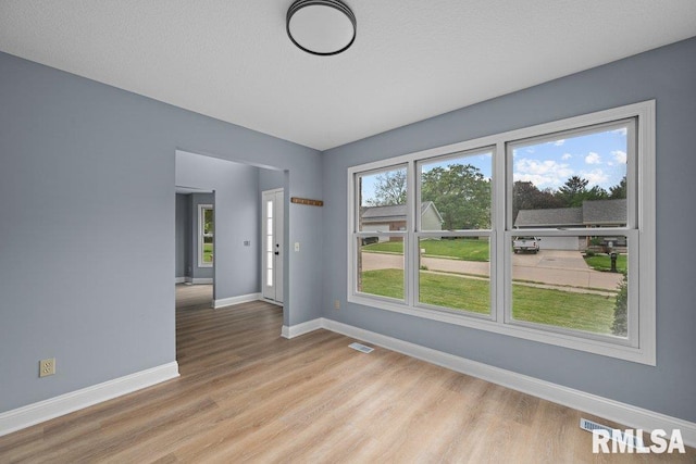 3217 Arlington Cir, Davenport, IA 52803 - spare room featuring baseboards and light wood-style floors