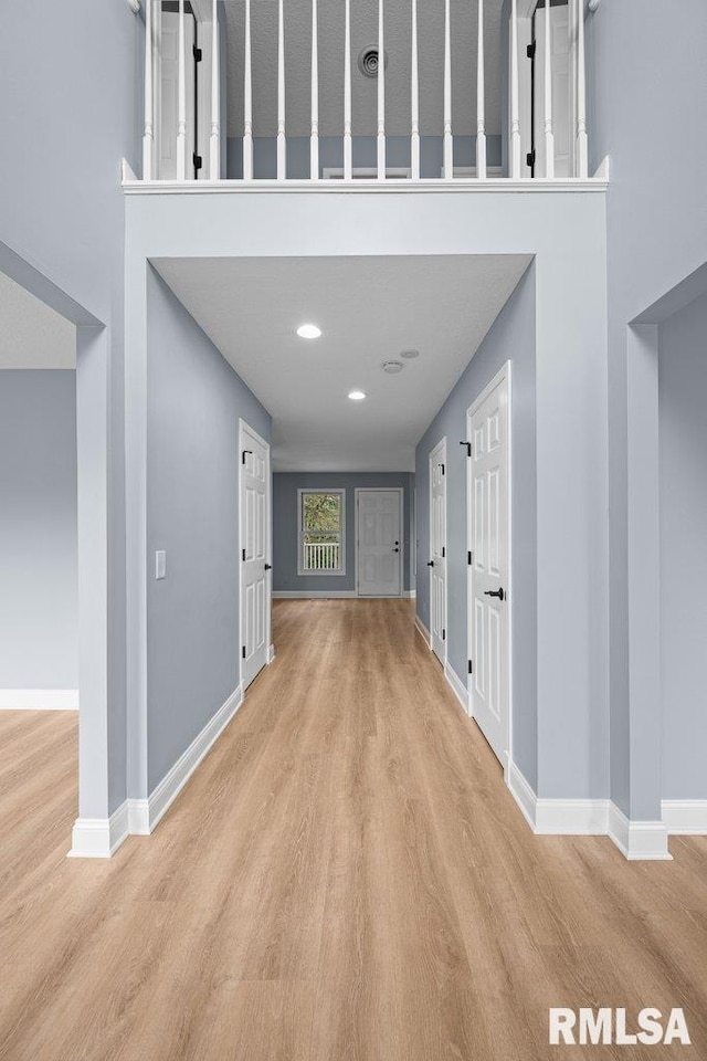 3217 Arlington Cir, Davenport, IA 52803 - corridor featuring wood finished floors, baseboards, and a towering ceiling