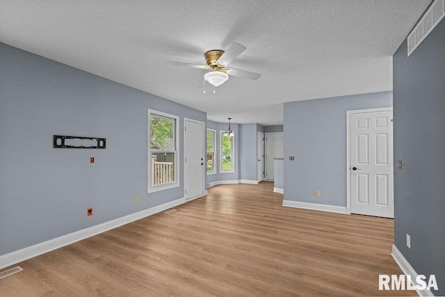 3217 Arlington Cir, Davenport, IA 52803 - unfurnished room featuring ceiling fan, baseboards, light wood finished floors, and a textured ceiling