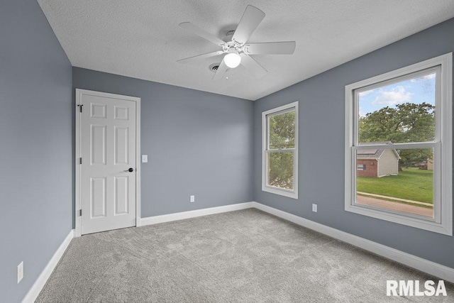 3217 Arlington Cir, Davenport, IA 52803 - carpeted spare room featuring a textured ceiling, baseboards, and a ceiling fan