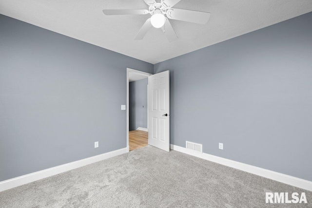 3217 Arlington Cir, Davenport, IA 52803 - spare room with carpet floors, baseboards, and ceiling fan