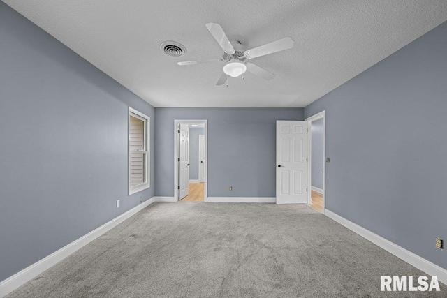 3217 Arlington Cir, Davenport, IA 52803 - unfurnished bedroom featuring a textured ceiling, light carpet, baseboards, and a ceiling fan