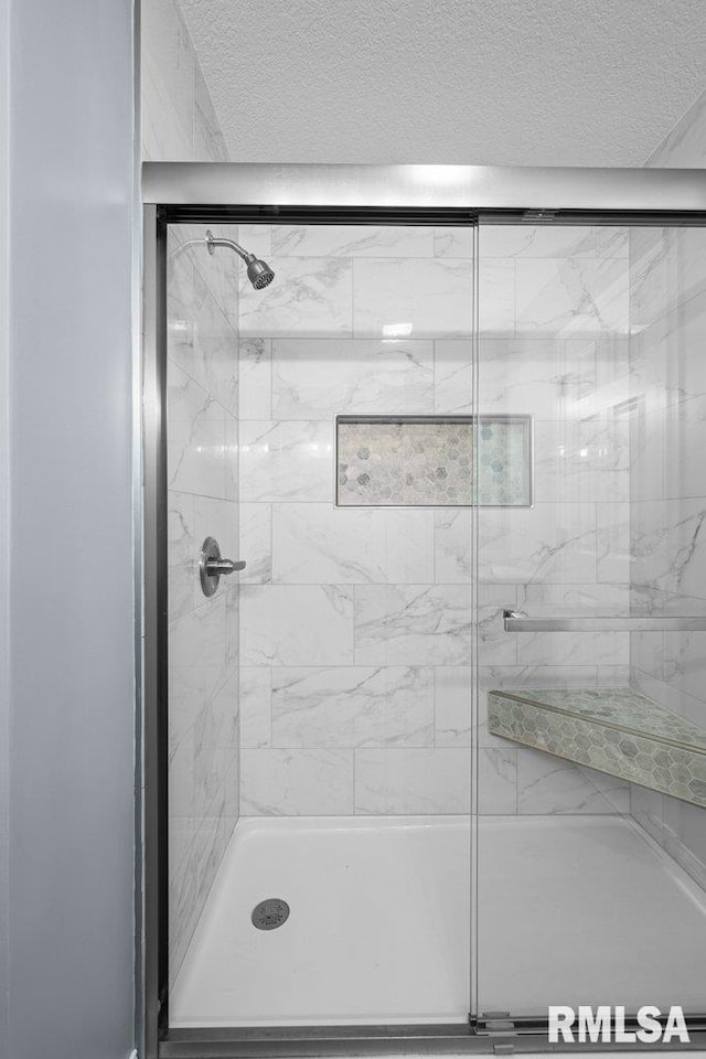 3217 Arlington Cir, Davenport, IA 52803 - bathroom with a stall shower and a textured ceiling