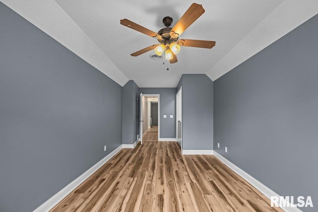 3217 Arlington Cir, Davenport, IA 52803 - additional living space featuring lofted ceiling, ceiling fan, baseboards, and light wood-type flooring