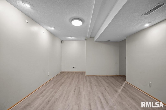 3217 Arlington Cir, Davenport, IA 52803 - finished basement with a textured ceiling, wood finished floors, and baseboards