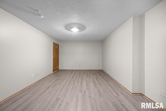 3217 Arlington Cir, Davenport, IA 52803 - unfurnished room featuring wood finished floors, a textured ceiling, and baseboards