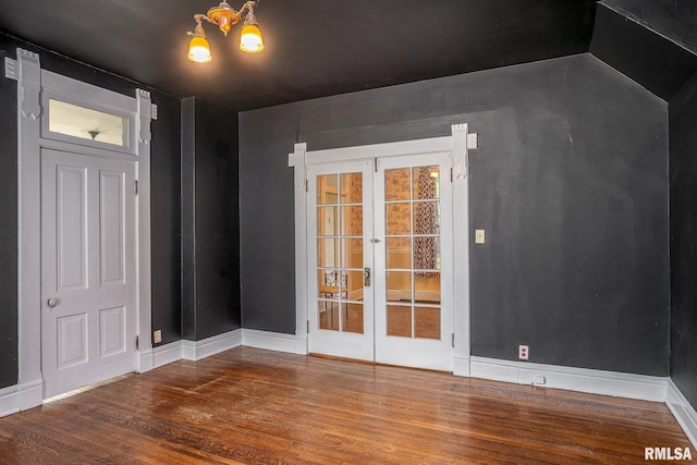 232 E 13th St, Davenport, IA 52803 - spare room with wood finished floors, a chandelier, french doors, and baseboards