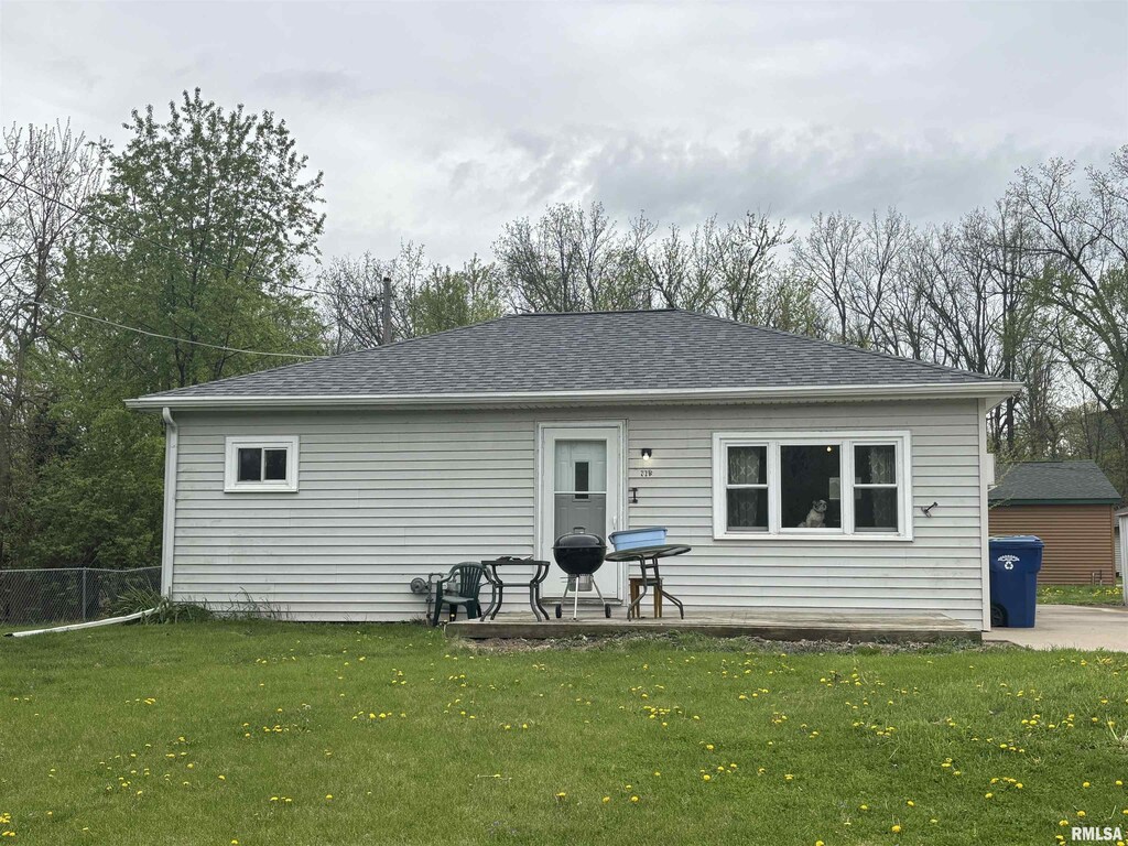 rear view of house with roof with shingles