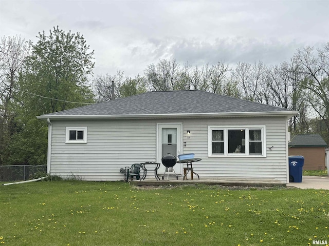 rear view of house with roof with shingles