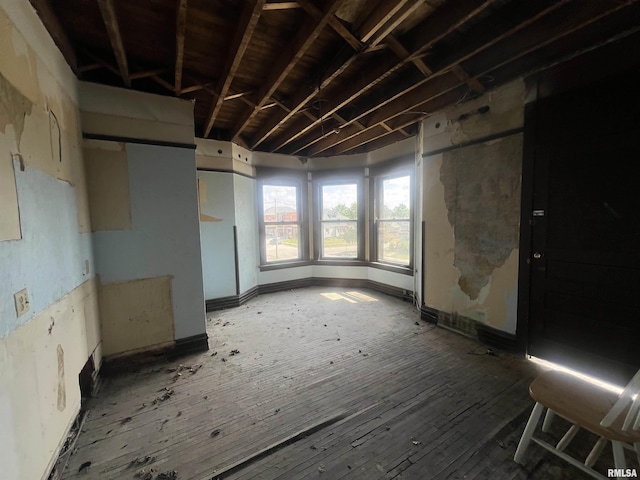 miscellaneous room featuring wood-type flooring and baseboards